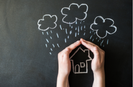 hands protects a house from the elements, rain or storm, homeowners insurance